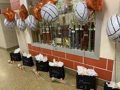 basketball themed birthday party decorations with balloons and streamers in front of the store window