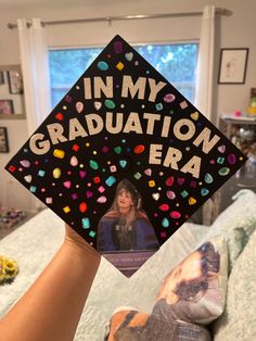 someone is holding up a graduation cap with the words in my graduation era on it