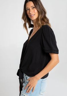 Designed in a fresh linen blend, our charming short sleeve top is a must-have style for Spring. With flirty short puff sleeves, an adjustable tie front waist, and a pretty self-covered button front. We love to style this effortless blouse with denim and a classic leather sandal. FINAL SALE Linen blend Relaxed fit Short puff sleeve Elastic cuff Tie front waist V-neckline Self-covered button front Pintuck details Lattice trim Classic bohemian top Model is 5'8, wearing a size S.Style: I-13804W-RJX Summer Solid Color Tops With Tie Waist, Chic Short Sleeve Tops For Brunch, Solid Color Summer Top With Tie Waist, Summer Solid Top With Tie Waist, Solid Summer Top With Tie Waist, Summer Puff Sleeve Top With Short Sleeves, Casual Blouse With Tie Sleeves, Casual Short Sleeve Blouse With Tie Sleeves, Trendy Puff Sleeve Top With Short Sleeves