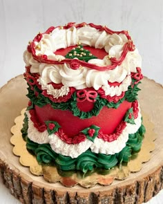 a decorated christmas cake sitting on top of a wooden slice