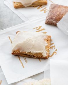 there is a pastry on top of some napkins and two other pastries are in the background