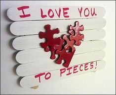 i love you to pieces sign with red and pink puzzle pieces on white planks