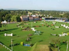 an aerial view of a soccer field with many chairs and benches around it, in the middle of a park