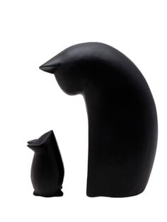 a black cat and its baby sitting next to each other in front of a white background