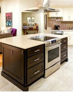 a kitchen with an island and stove top oven