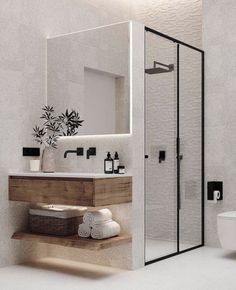 a bathroom with a toilet, sink and shower stall