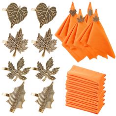 orange napkins with gold leaf decorations on them and matching napkin clips in the shape of hearts