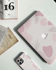 an apple phone case sitting on top of a table next to a book and magazine