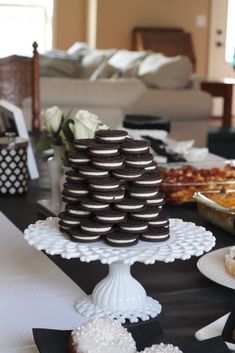 a table topped with lots of desserts and cookies on top of it's plates