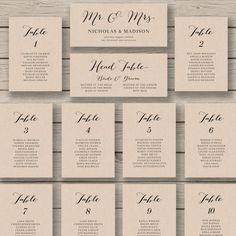 wedding seating cards with the names and numbers on them, sitting on a wooden table