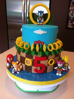 a birthday cake with sonic the hedgehog decorations on it's top and numbers