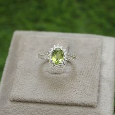 * Material: 925 Sterling Silver * DETAILS ✥ Handmade Ring ✥ - Center Stone: Natural Peridot - Center Stone Size: 6X8 MM - Center Stone Shape: Oval - Side Stone: CZ Diamond ✥ O T H E R ∙ I N F O R M A T I ON ✥ ♦ Your item will be nicely packed to gift in elegant jewelry boxes. ♦ Custom Order We can make custom rings in almost any shape and style. If you want a specific model, please send us a clear picture and we will do our best. ♦ Delivery All Item will be Shipped within 3 to 5 Days after payment receive. The delivery time usually takes 11 to 23 days, depending which Country & location. ♦ Payment we accept payment through PayPal only, Payment should be made within 3 days of purchase. ♦ Ring Size Visit your local jeweller to be sized, (Most offer this service for free). I can make this rin Peridot Ring Engagement, Peridot Engagement Rings, August Birthstone Ring, Green Gemstone Ring, Cute Engagement Rings, August Birthstone, Birthday Ring, Peridot Ring, Silver Engagement Rings