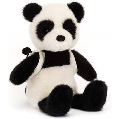 a black and white stuffed panda bear sitting up against a white background with one paw in the air