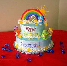 a two tiered birthday cake on a table with confetti scattered around it