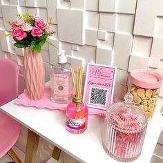 a table topped with pink flowers and personal care items