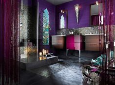 a bathroom with purple walls and black flooring