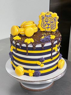 a decorated cake with yellow and purple decorations