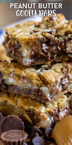 peanut butter gooey bars stacked on top of each other with chocolate chips and candy