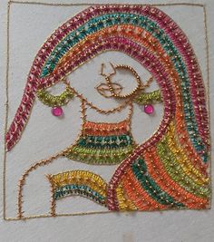 a drawing made out of beads with a woman's face in the center and colorful hair