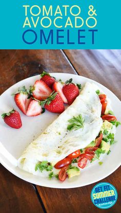 an omelet with strawberries and avocado is on a white plate