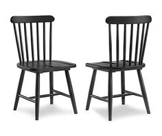 a pair of black chairs sitting next to each other