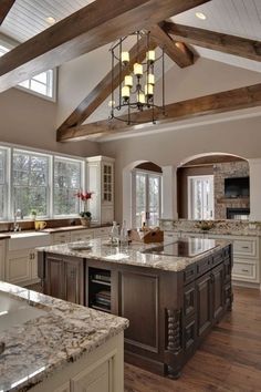 a large kitchen with marble counter tops and an island in the middle of the room