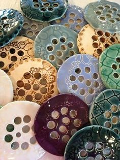 many different colored plates with holes in them