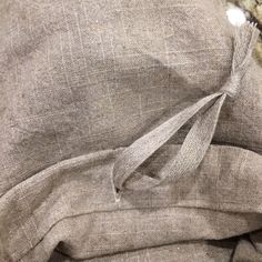 a close up of a pillow with a knot on the end and some fabric around it