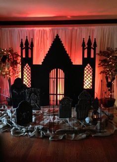 a room decorated for halloween with pumpkins and tombstones