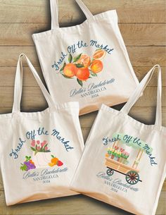 three bags with fruit on them sitting on top of a wooden table next to each other