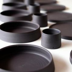 many black plates are lined up on the table