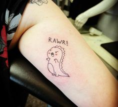 a person with a tattoo on their arm that says rawr