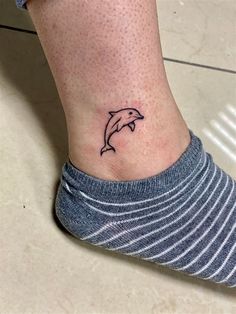 a small dolphin tattoo on the ankle