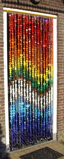 the door is made out of bottles and has a multicolored design on it