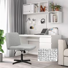 a white desk and chair in a room with bookshelves on the wall behind it