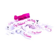 pink and white lanyards with wine glasses on them for bridal party favors