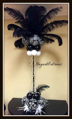 a black and white centerpiece with feathers on it