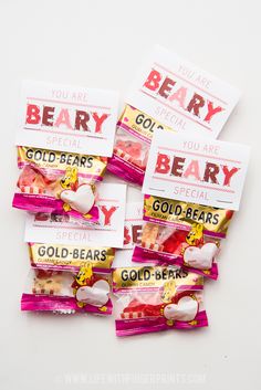 four bags of beary candy sitting on top of each other in front of a white background