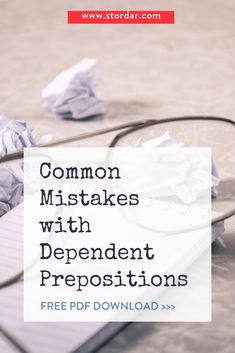 a pile of papers sitting on top of a desk next to a computer mouse and keyboard