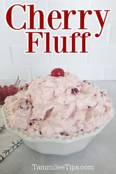 a close up of a bowl of food with cherries on the side and text overlay reading cherry fluff