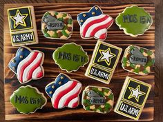 decorated cookies are arranged on a wooden board with the names and symbols of different countries