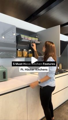 a woman standing in front of a kitchen counter with the words 8 must - have kitchen features