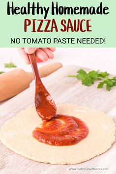 the homemade pizza sauce is being drizzled on top of tortilla