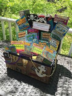 a trunk filled with books sitting on top of a porch