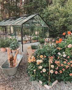 a woman in a garden tub surrounded by flowers