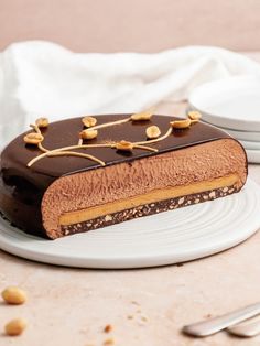 a piece of chocolate cake sitting on top of a white plate next to a fork