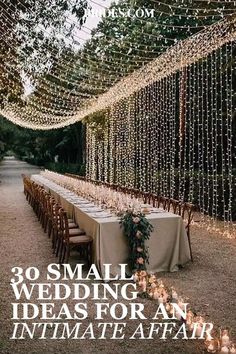 a long table is set up with candles and greenery for an outdoor wedding reception