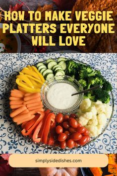 a platter filled with veggies and dip surrounded by other vegetables