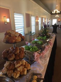 a buffet line with breads and pastries on it