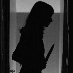 the silhouette of a woman holding a knife